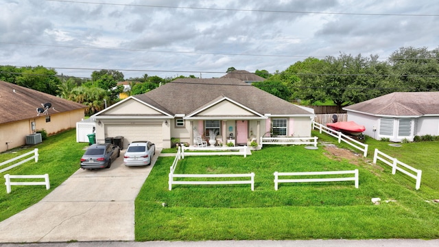 ranch-style house featuring central AC unit, a garage, and a front lawn