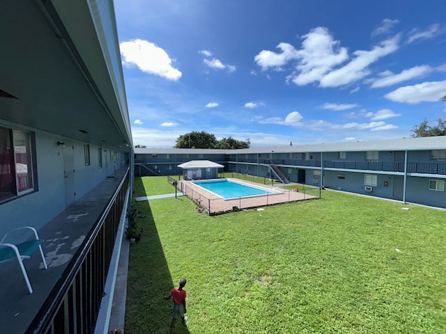 view of swimming pool with a lawn