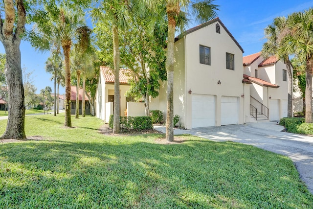 view of front of house with a front yard and a garage