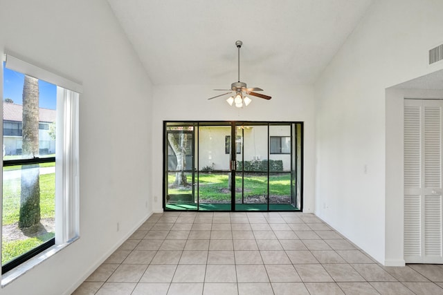 tiled spare room with ceiling fan and vaulted ceiling