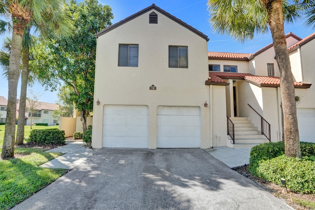 mediterranean / spanish-style house with a garage