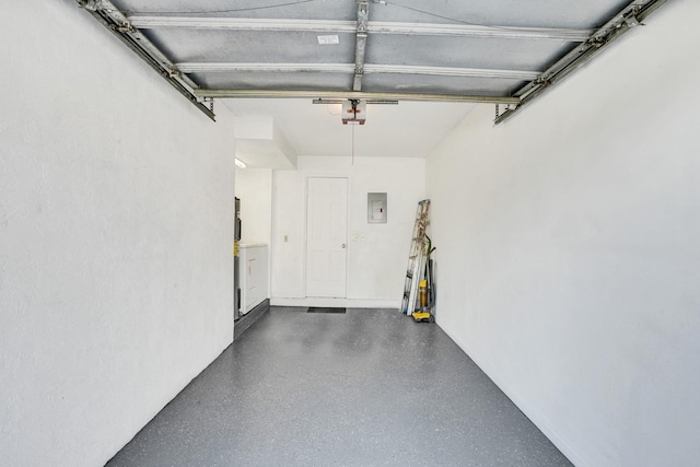 garage with a garage door opener and electric panel