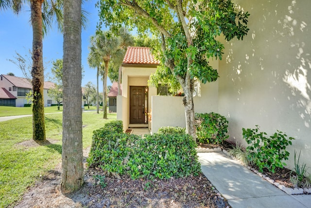 entrance to property with a yard