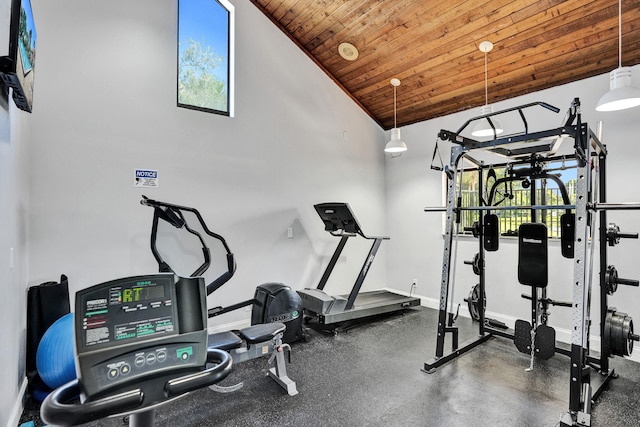 workout area featuring wood ceiling and vaulted ceiling