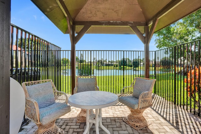 view of patio / terrace featuring a gazebo and a water view