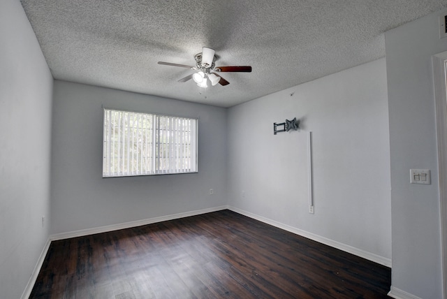 unfurnished room with a textured ceiling, ceiling fan, and dark hardwood / wood-style flooring