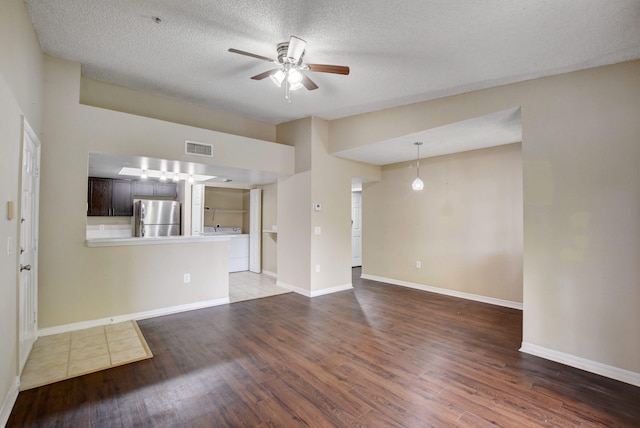 unfurnished living room with ceiling fan, wood-type flooring, and a textured ceiling