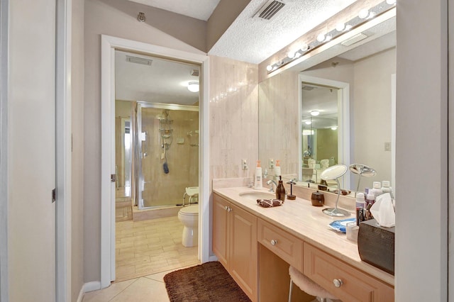 bathroom featuring vanity, tile patterned flooring, an enclosed shower, a textured ceiling, and toilet