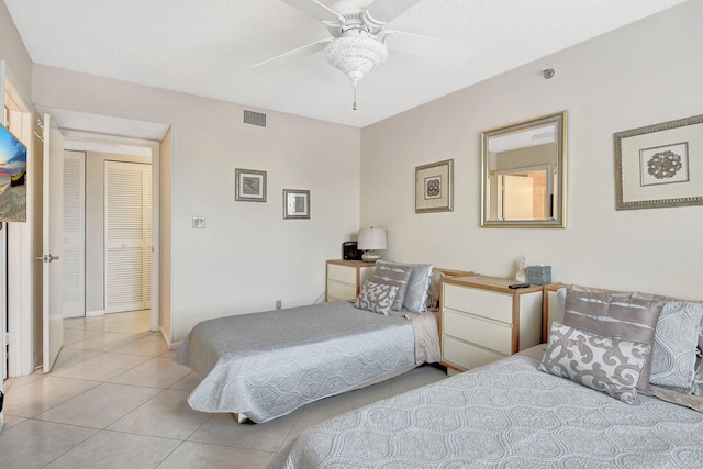 bedroom featuring light tile patterned floors and ceiling fan