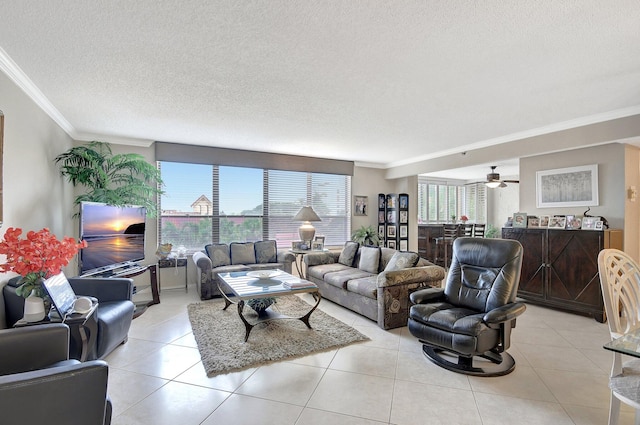 tiled living room with ornamental molding, ceiling fan, and a textured ceiling