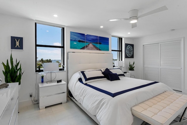 bedroom with ceiling fan and a closet