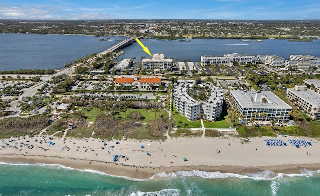 aerial view with a water view and a beach view