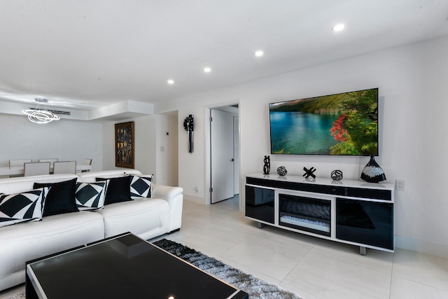 tiled living room featuring an inviting chandelier