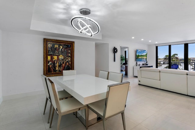 dining area featuring a wall of windows and an inviting chandelier