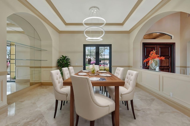 dining space featuring crown molding, french doors, and a tray ceiling