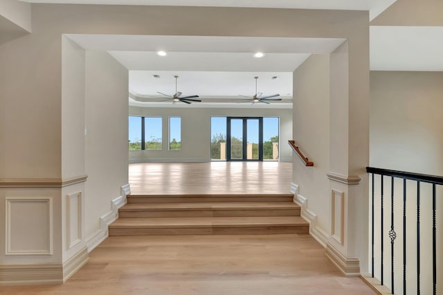 staircase featuring hardwood / wood-style floors and ceiling fan