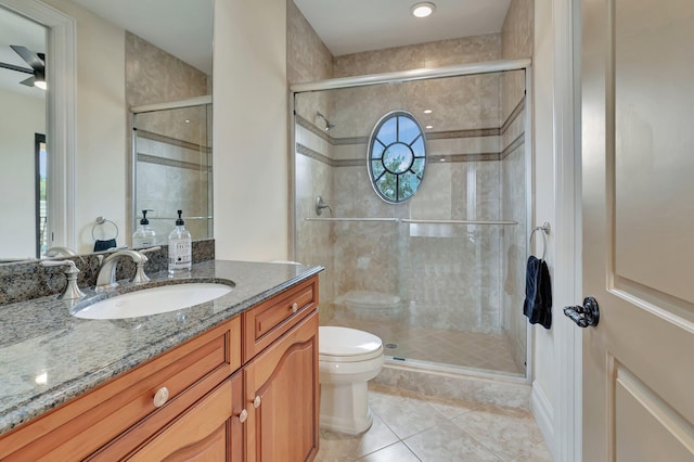 bathroom with a shower with shower door, tile patterned floors, vanity, and toilet