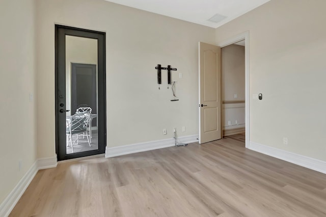 spare room with light wood-type flooring