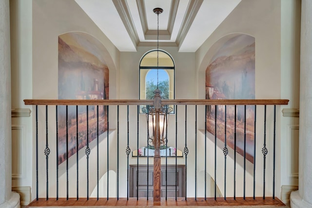 room details featuring a raised ceiling, crown molding, and a chandelier