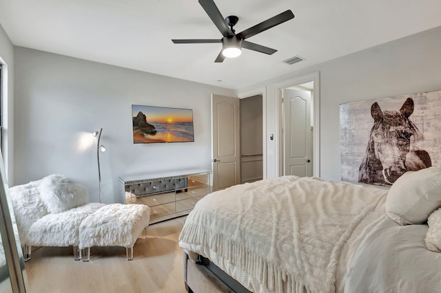 bedroom with light wood-type flooring and ceiling fan