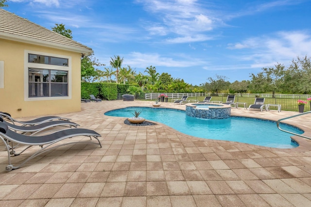 view of swimming pool with a patio area and an in ground hot tub