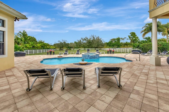 view of swimming pool featuring a patio and an in ground hot tub