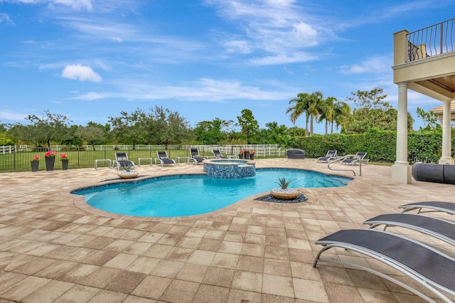 view of swimming pool featuring a patio area and an in ground hot tub