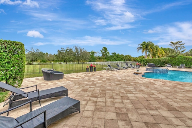 view of pool featuring pool water feature and a patio area