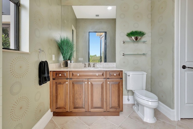 bathroom featuring vanity, tile patterned floors, and toilet