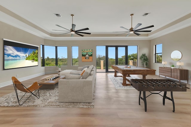 interior space with a raised ceiling, french doors, crown molding, and billiards