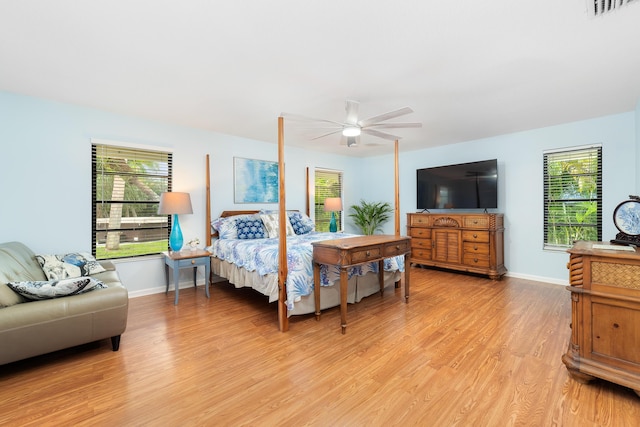bedroom with ceiling fan, baseboards, visible vents, and light wood-style flooring