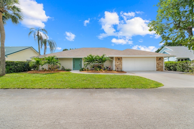 single story home featuring a front lawn and a garage