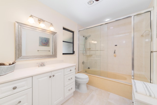 bathroom with vanity, enclosed tub / shower combo, tile patterned floors, and toilet