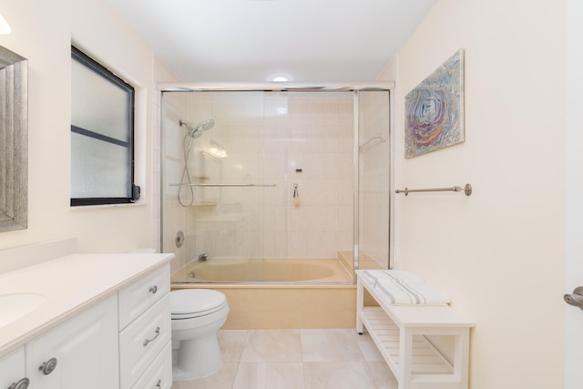 full bathroom with vanity, bath / shower combo with glass door, toilet, and tile patterned floors