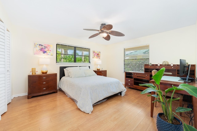 bedroom featuring multiple windows, light wood-type flooring, and ceiling fan