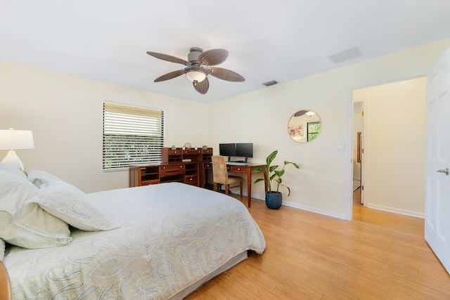 bedroom featuring baseboards, visible vents, ceiling fan, and light wood finished floors