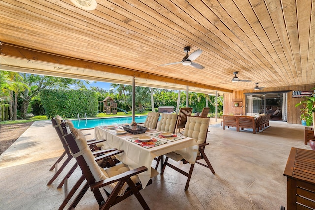 view of patio / terrace with outdoor dining area, a ceiling fan, an outdoor pool, and a playground
