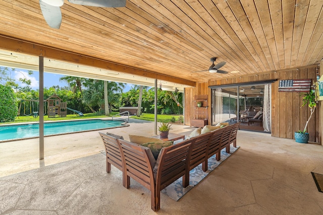exterior space with an outdoor living space, a ceiling fan, a playground, and an outdoor pool