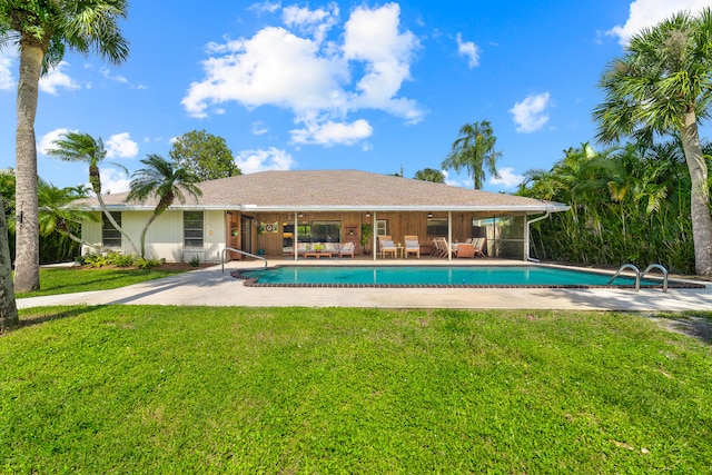 view of pool with a yard and a patio area