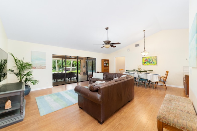 living room with visible vents, lofted ceiling, baseboards, a ceiling fan, and light wood finished floors