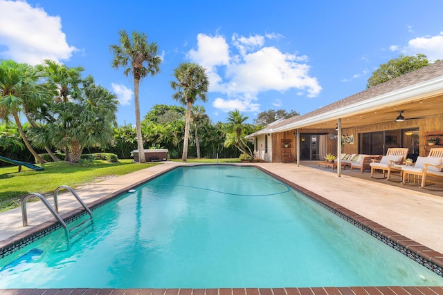 pool featuring ceiling fan, a yard, and a patio area