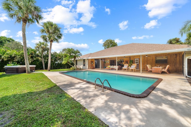 outdoor pool featuring ceiling fan, outdoor lounge area, a patio area, a hot tub, and a yard