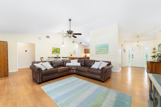living room with a ceiling fan, baseboards, visible vents, and light wood-type flooring