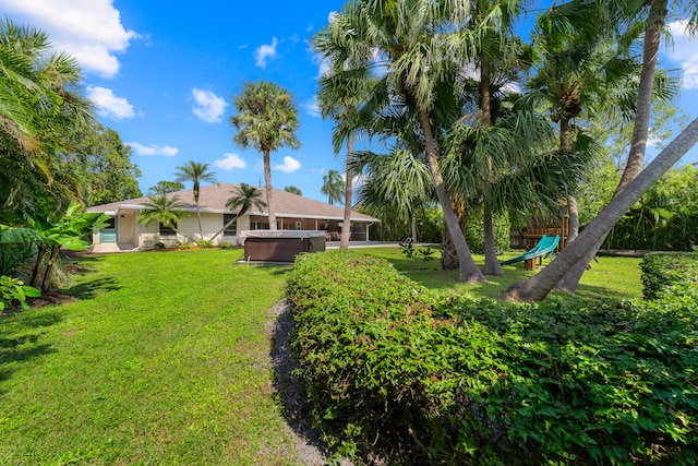 view of yard with a hot tub