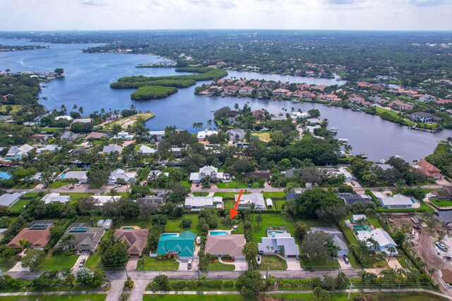 drone / aerial view with a water view and a residential view