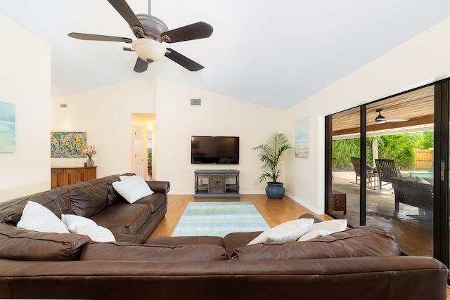 living room featuring vaulted ceiling, light hardwood / wood-style floors, and ceiling fan