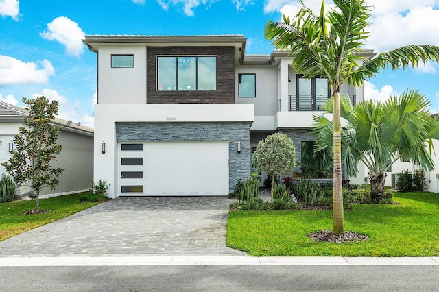 modern home with a garage and a front lawn