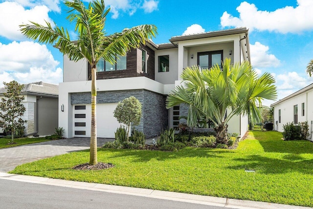 view of front of property with a front lawn and a garage