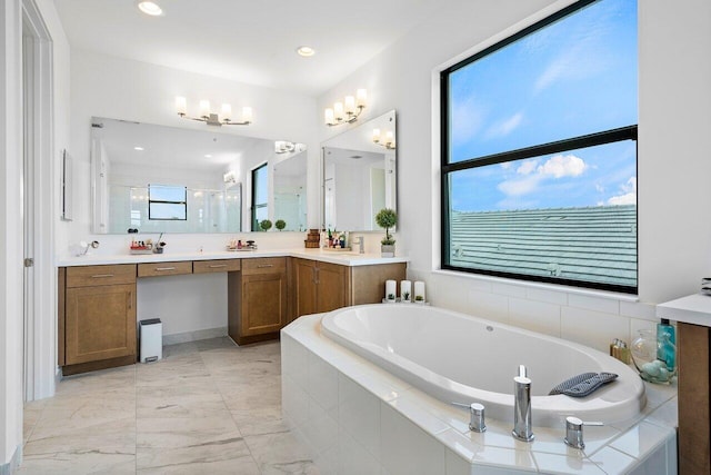 bathroom with a healthy amount of sunlight, vanity, and independent shower and bath