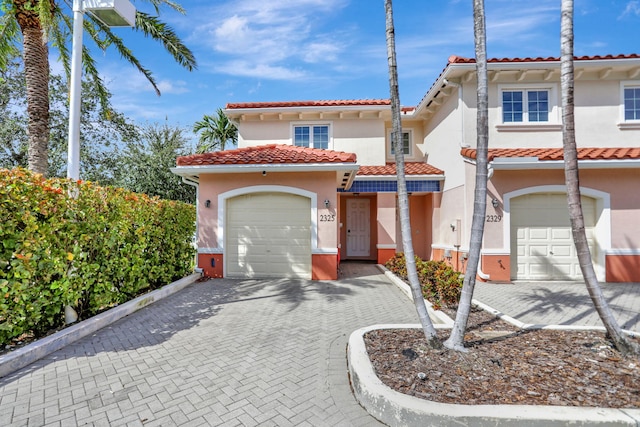 mediterranean / spanish house with a garage